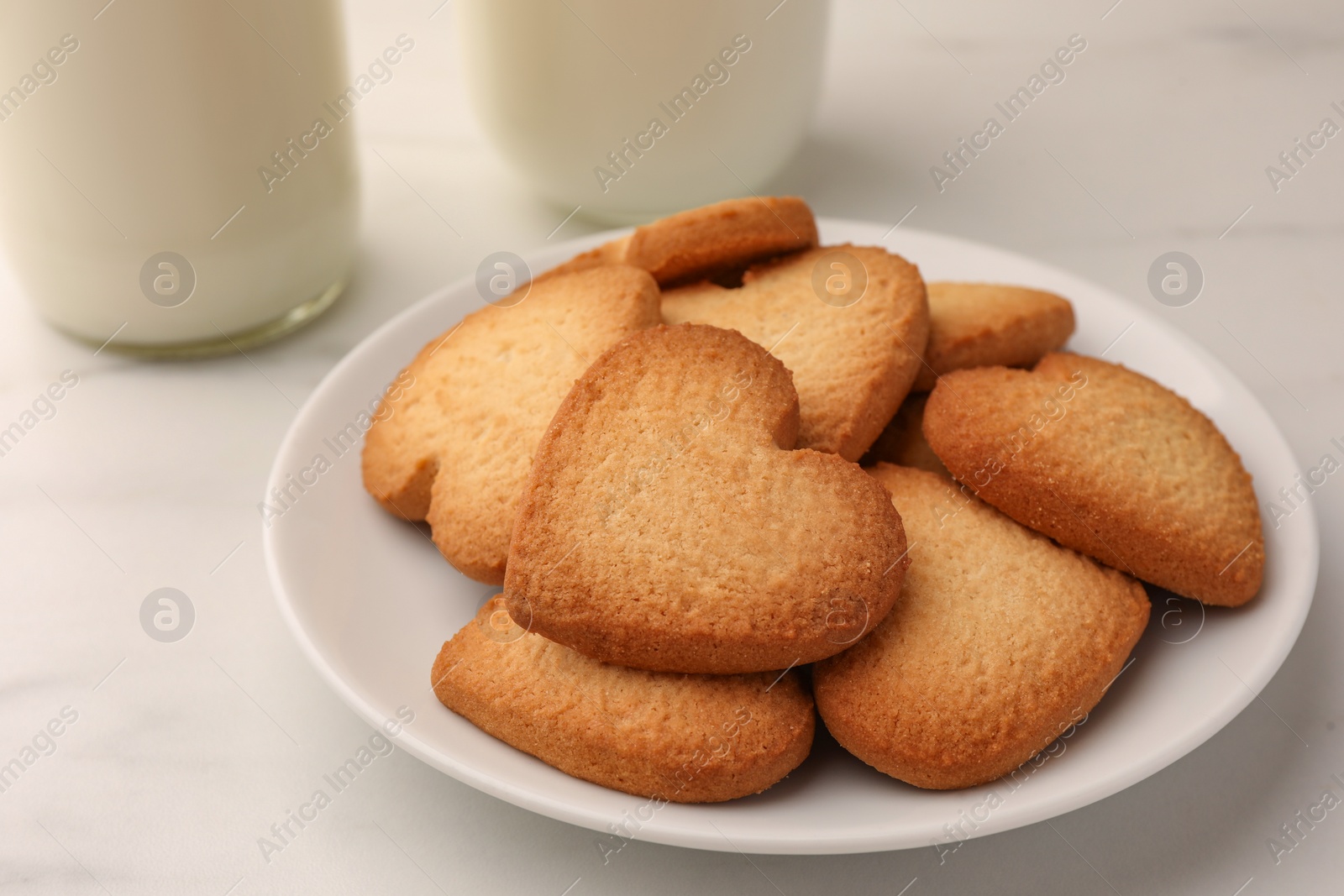 Photo of Heart shaped Danish butter cookies on white marble table, closeup