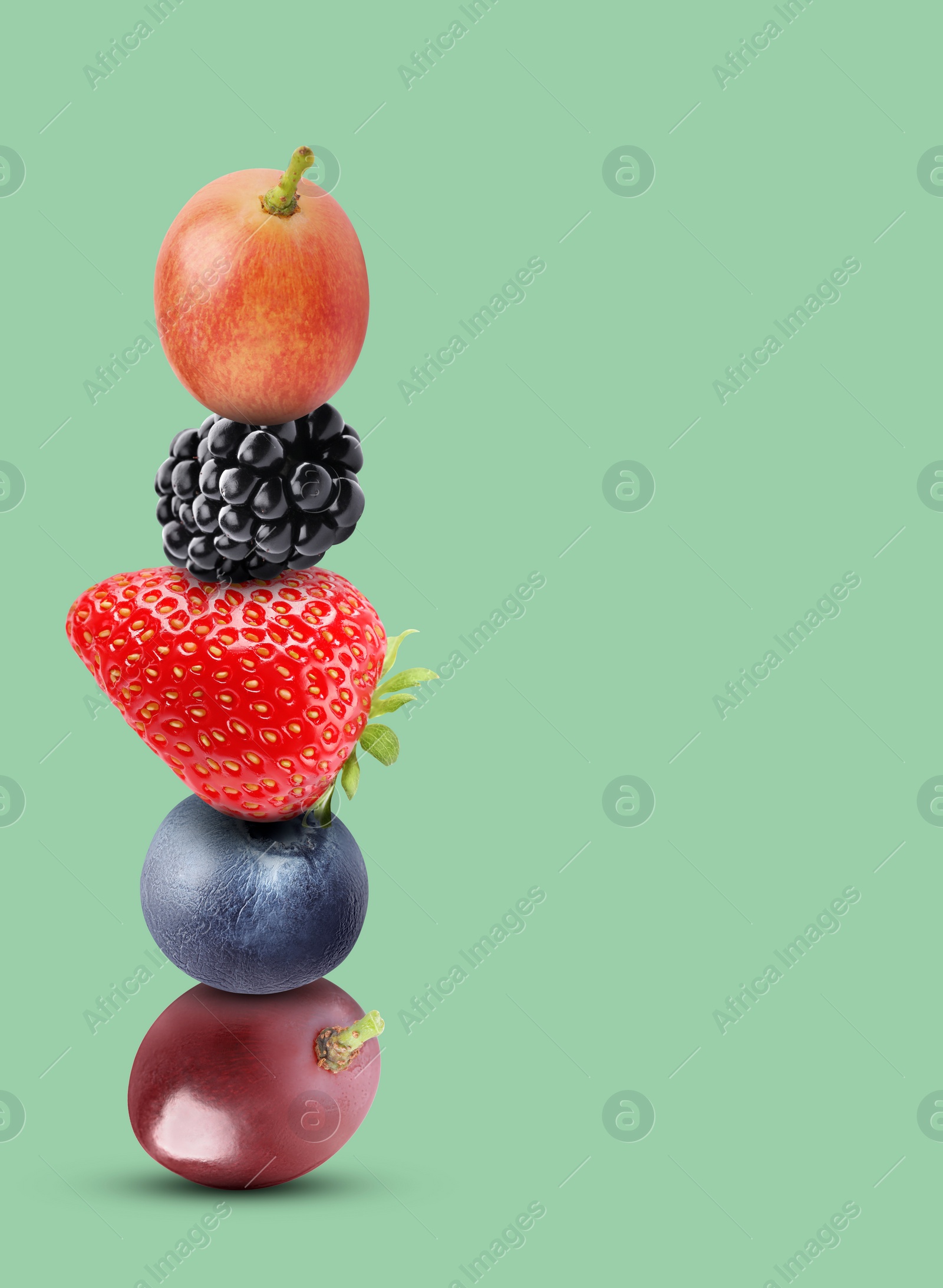 Image of Stack of different fresh tasty berries on pale aquamarine background, space for text