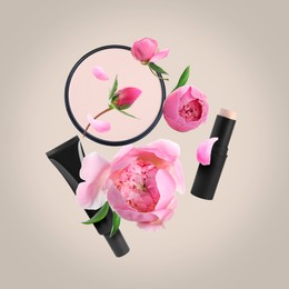 Image of Spring flowers and makeup products in air on dusty beige background