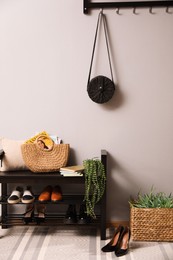 Photo of Hallway interior with stylish furniture, shoes and accessories