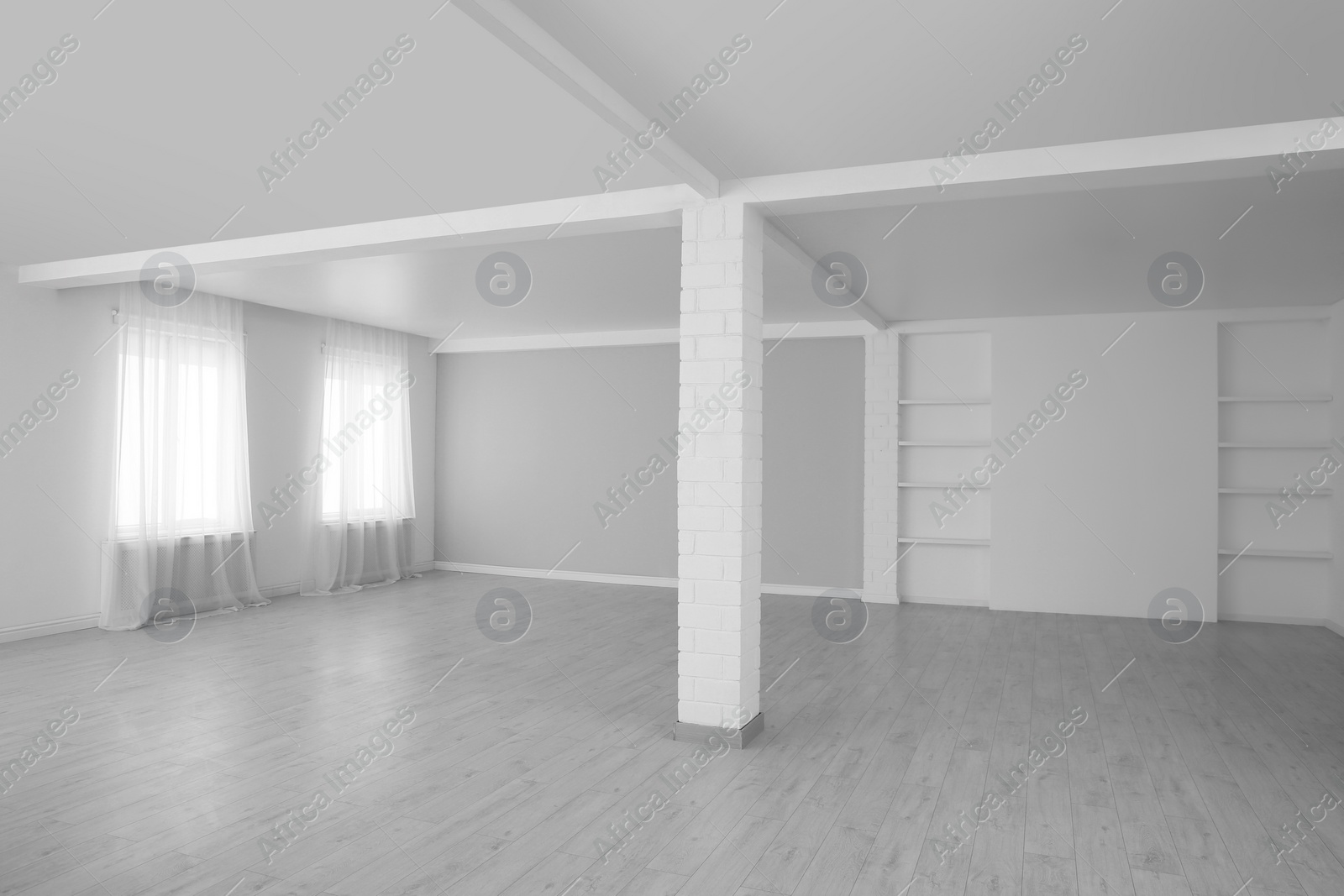 Photo of Empty room with large windows and laminated floor