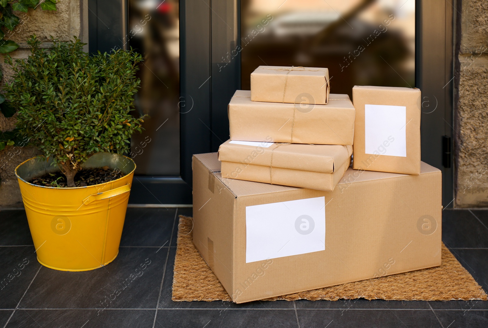 Photo of Delivered parcels on door mat near entrance