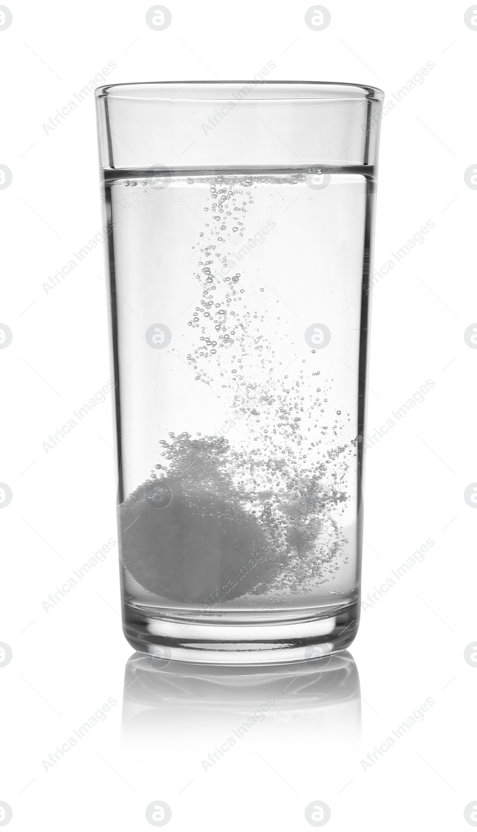 Photo of Effervescent pill dissolving in glass of water isolated on white