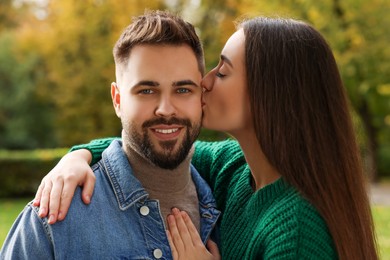 Photo of Happy young couple spending time together in autumn park