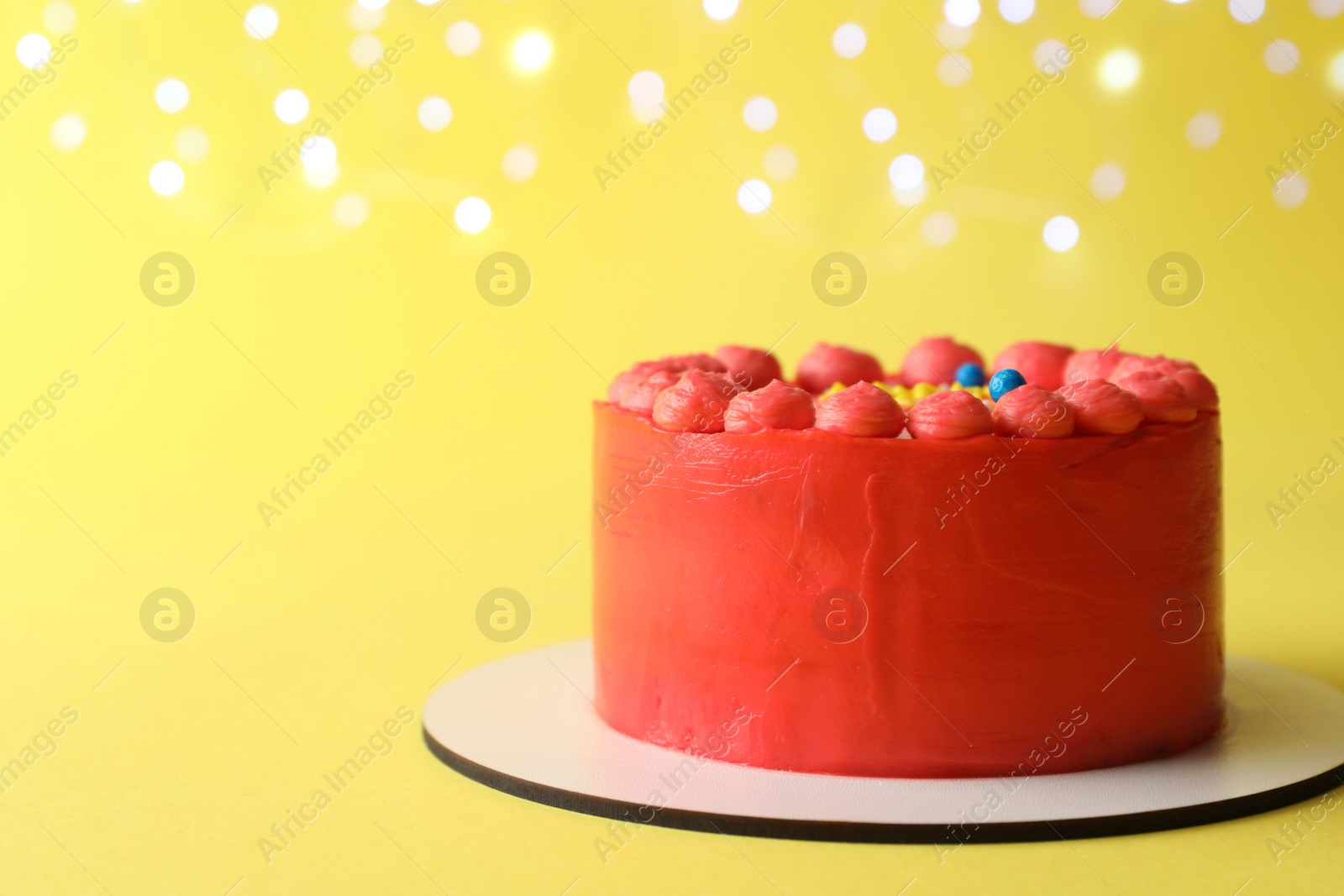 Photo of Cute bento cake with tasty cream on yellow background, space for text