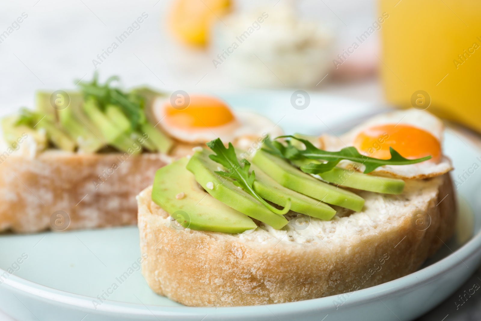 Photo of Plate of delicious avocado sandwiches on table, closeup