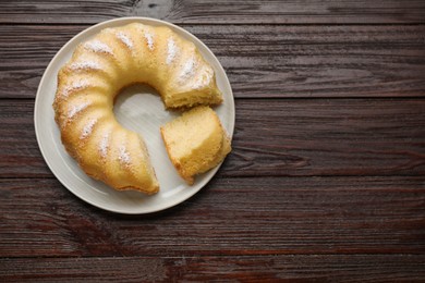 Photo of Delicious freshly baked sponge cake on wooden table, top view. Space for text