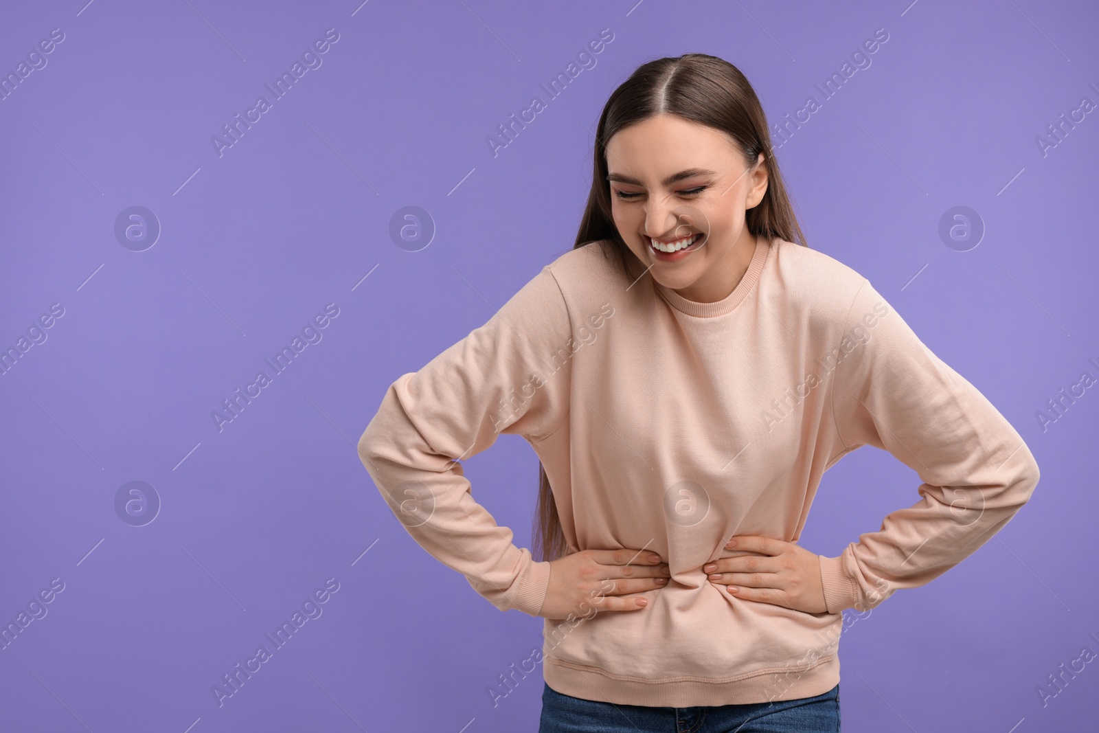 Photo of Beautiful woman laughing on violet background. Space for text