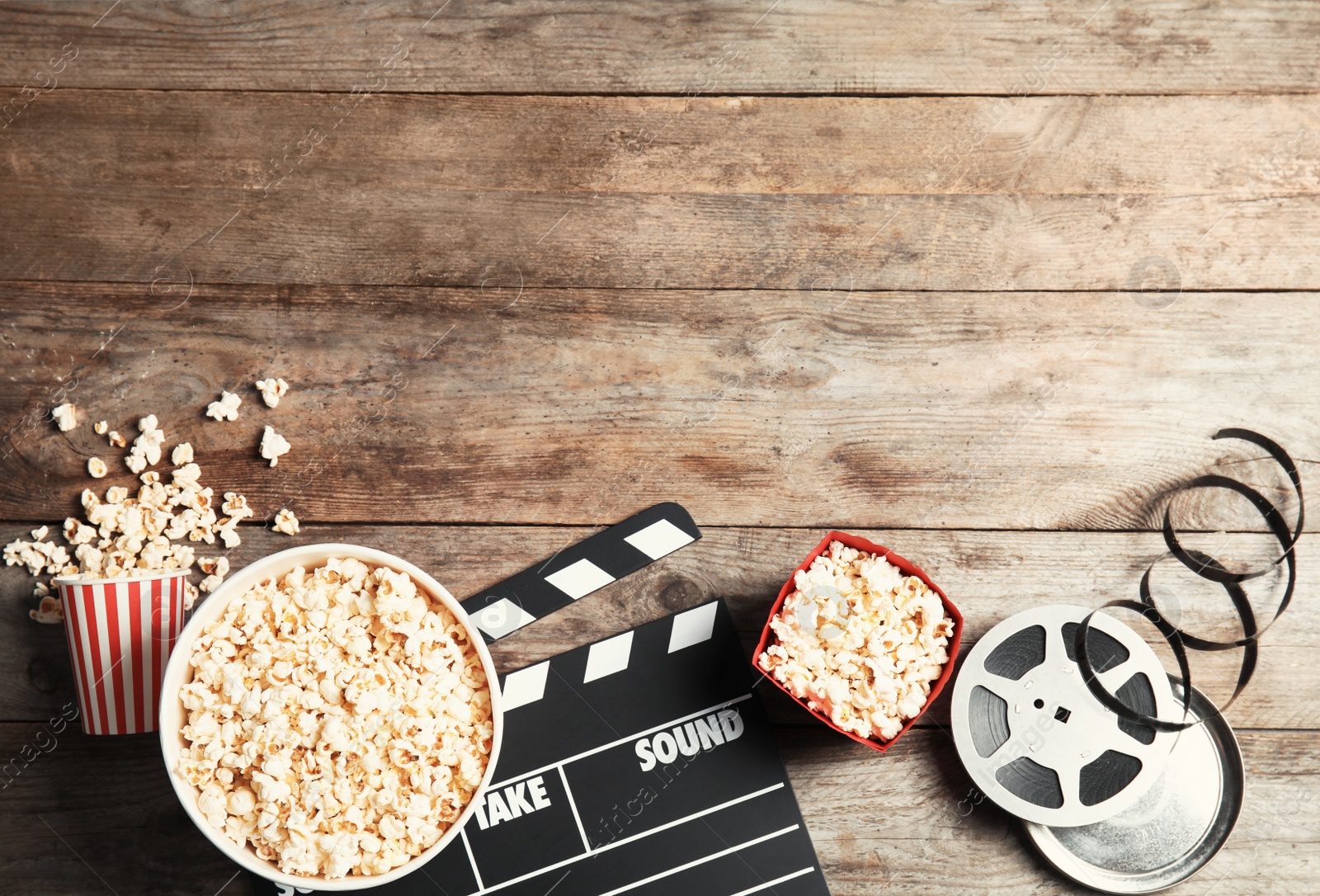 Photo of Flat lay composition with tasty popcorn and space for text on wooden background. Cinema snack