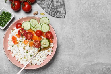 Photo of Delicious cottage cheese with vegetables served on light grey table, flat lay. Space for text