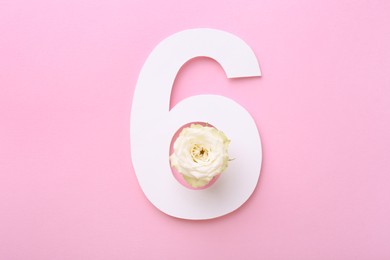 Photo of Paper number 6 and beautiful rose flower on pink background, top view