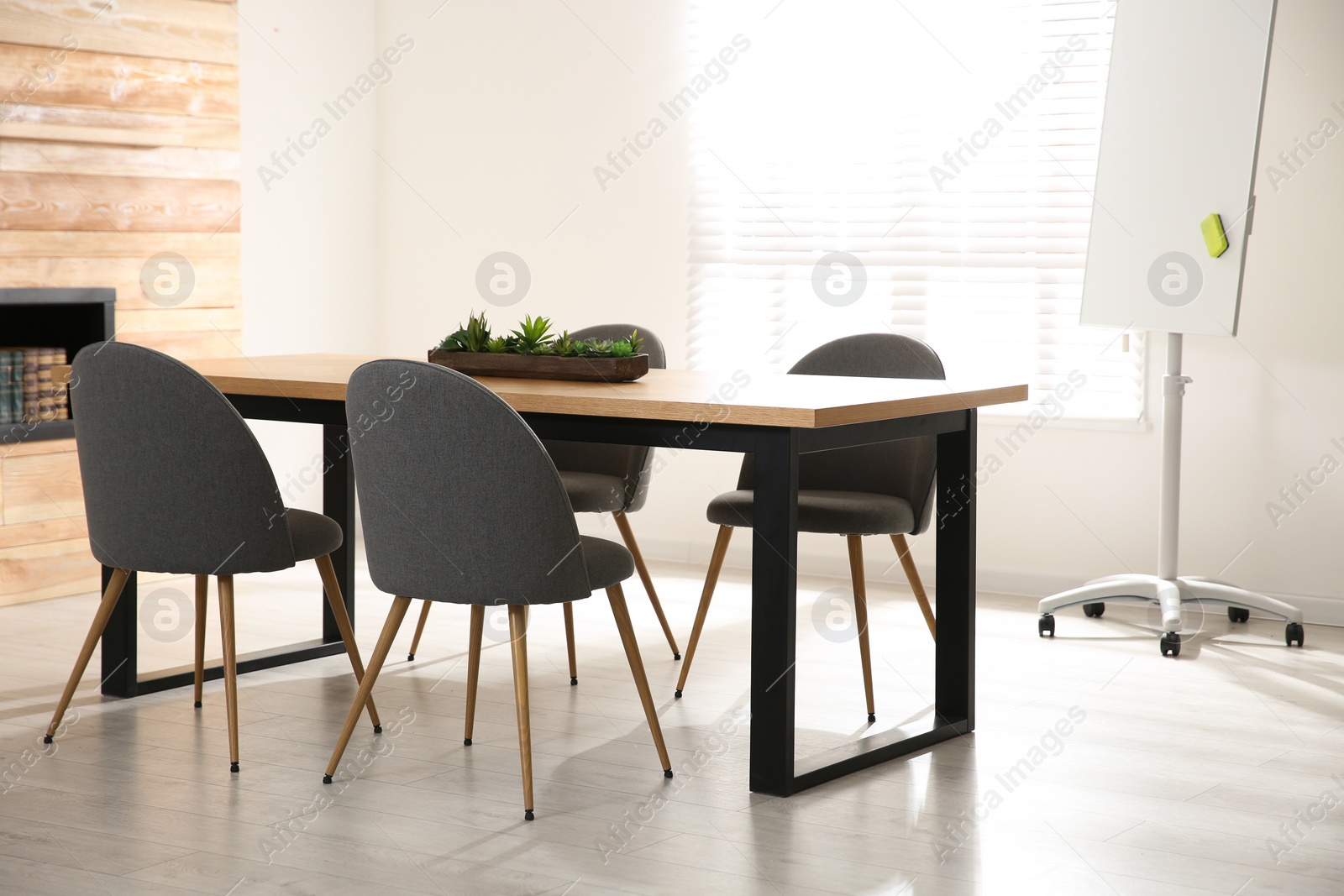 Photo of Modern meeting room interior with large table and chairs