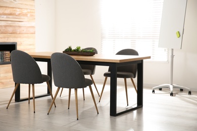 Modern meeting room interior with large table and chairs