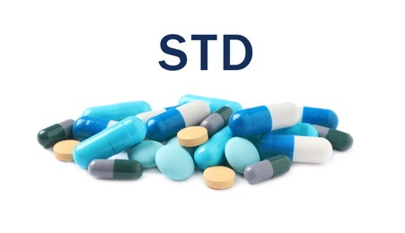 Different pills and abbreviation STD on white background