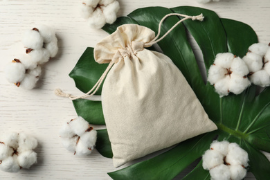 Photo of Full cotton eco bag on white wooden table, flat lay