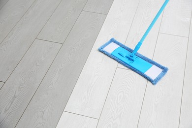 Image of Washing of parquet floor with mop. Difference before and after cleaning
