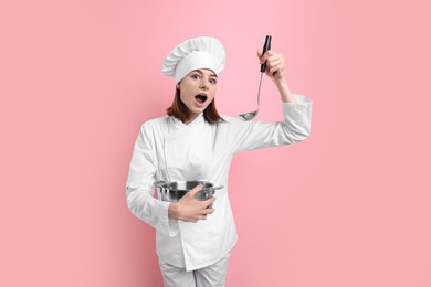 Professional chef cooking pot and ladle on pink background