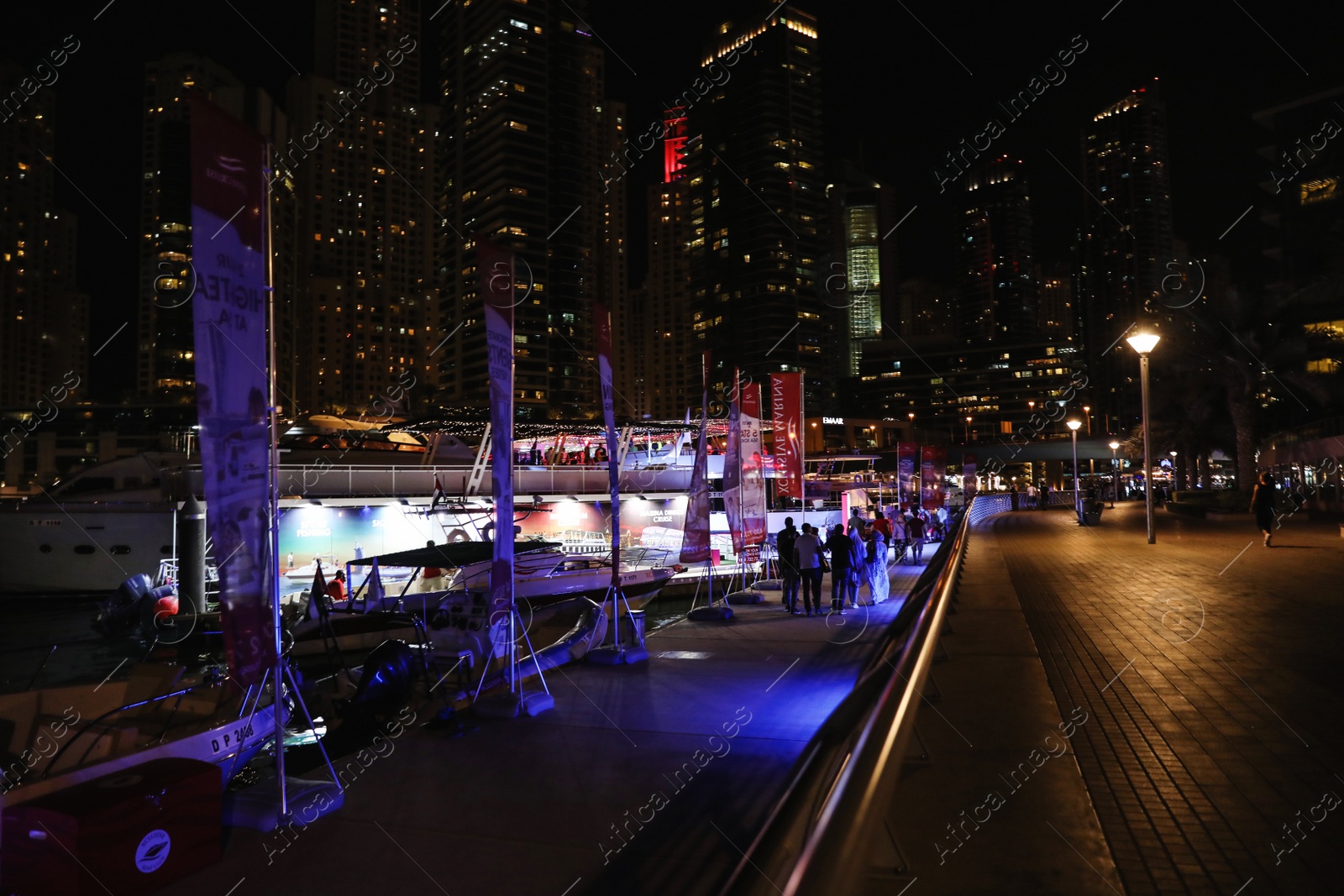 Photo of DUBAI, UNITED ARAB EMIRATES - NOVEMBER 03, 2018: Pier with luxury yachts at night