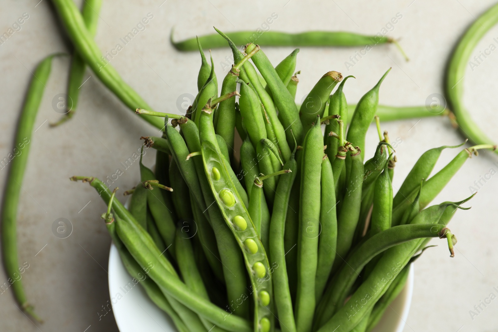 Photo of Fresh green beans on light grey table, flat lay