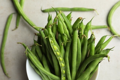 Photo of Fresh green beans on light grey table, flat lay