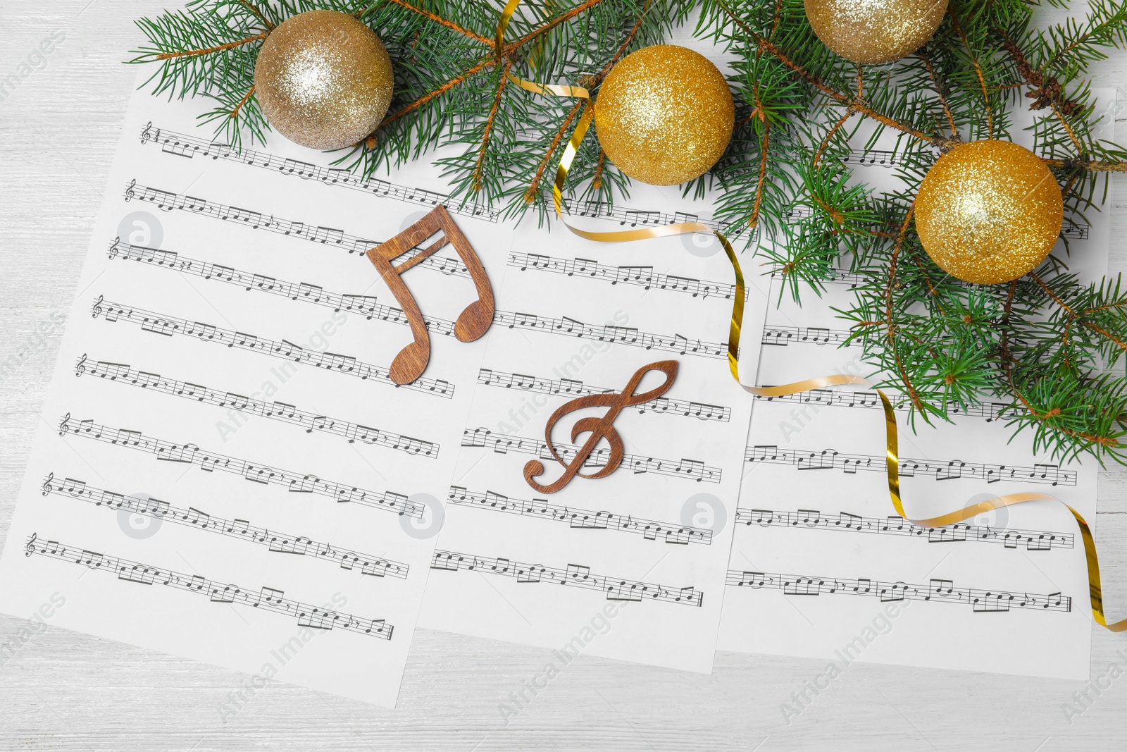 Photo of Flat lay composition with Christmas decor, music sheets and wooden notes on table