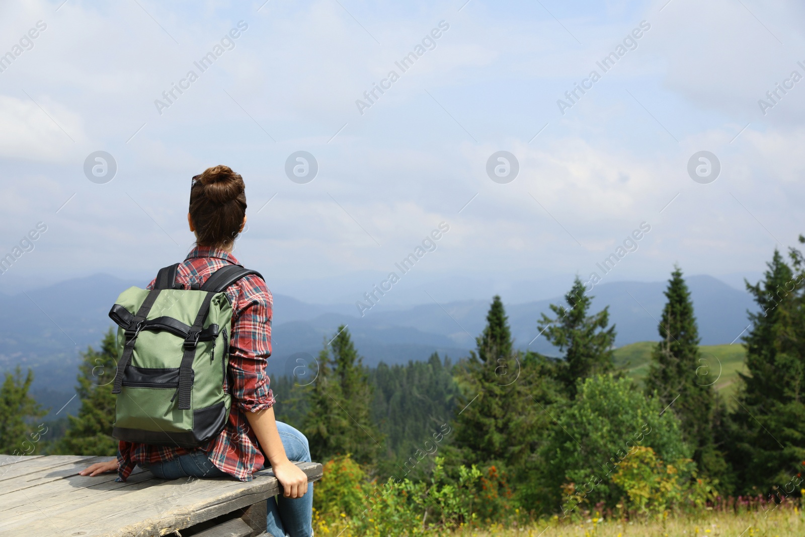 Photo of Woman with backpack in wilderness on cloudy day