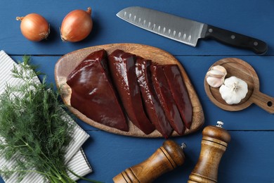 Photo of Flat lay composition with cut raw beef liver on blue wooden table