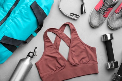 Flat lay composition with gym bag and sportswear on grey table