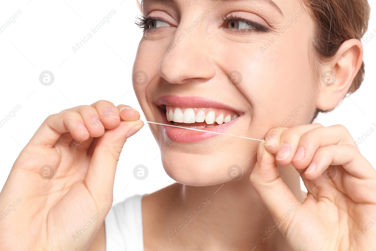 Photo of Young woman flossing her teeth on white background