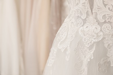 Beautiful wedding dress on mannequin in boutique, closeup