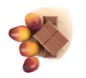 Fresh ripe palm oil fruits and chocolate on white background, top view