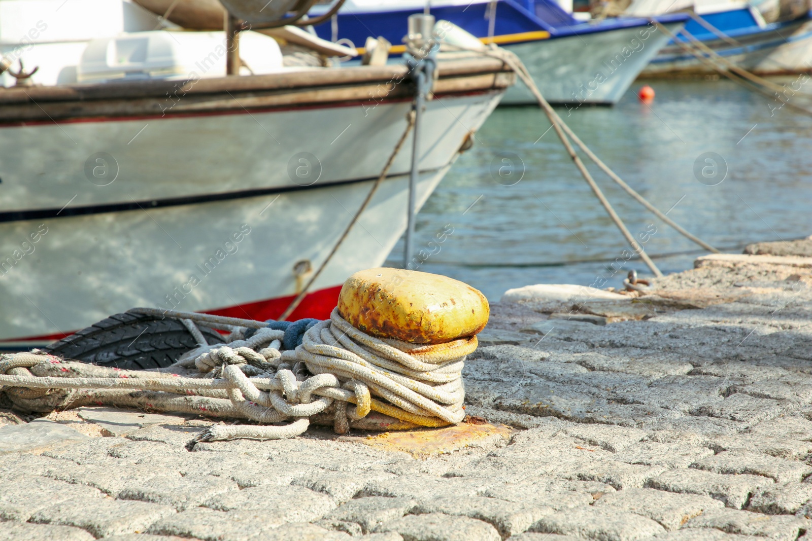 Photo of Mooring pole with rope in sea port