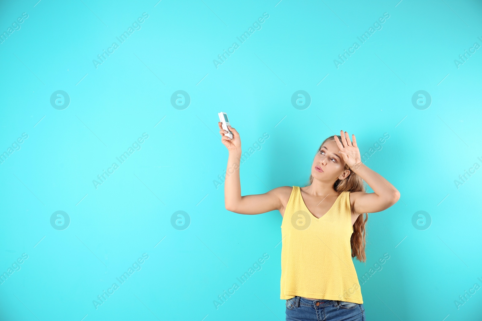 Photo of Young woman suffering from heat on color background with copy space text. Air conditioner malfunction