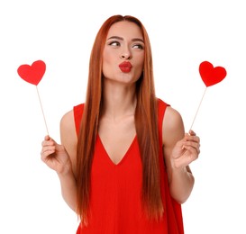 Young woman in red dress with paper hearts on white background