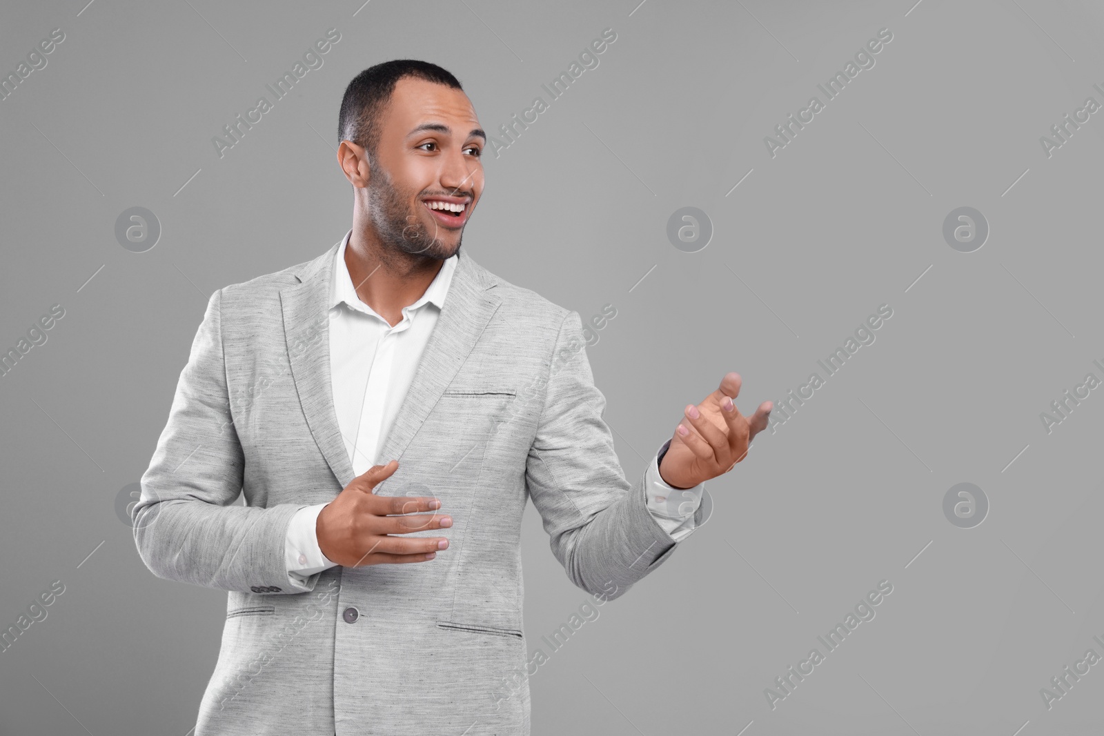 Photo of Young businessman in formal outfit on grey background. Space for text