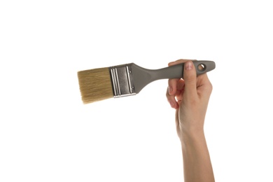 Photo of Woman holding paint brush on white background, closeup