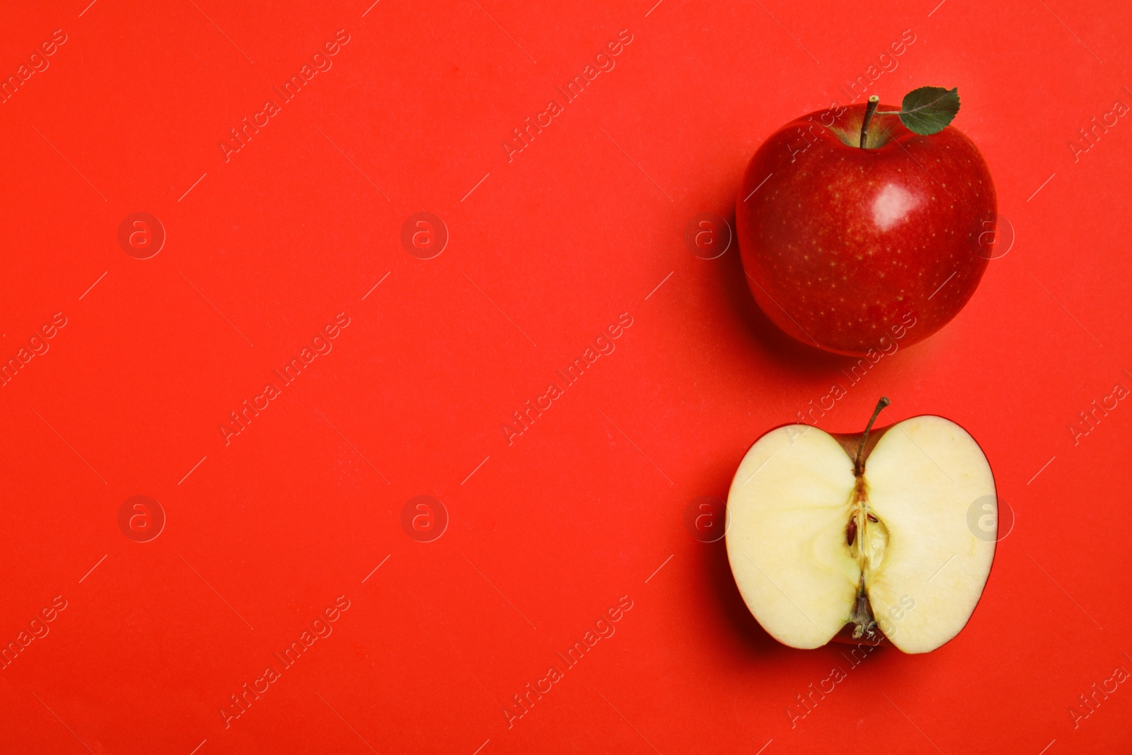 Photo of Flat lay composition with ripe juicy apples on red background, space for text