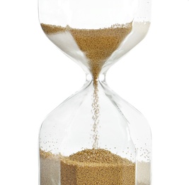 Photo of Hourglass with flowing sand on white background. Time management
