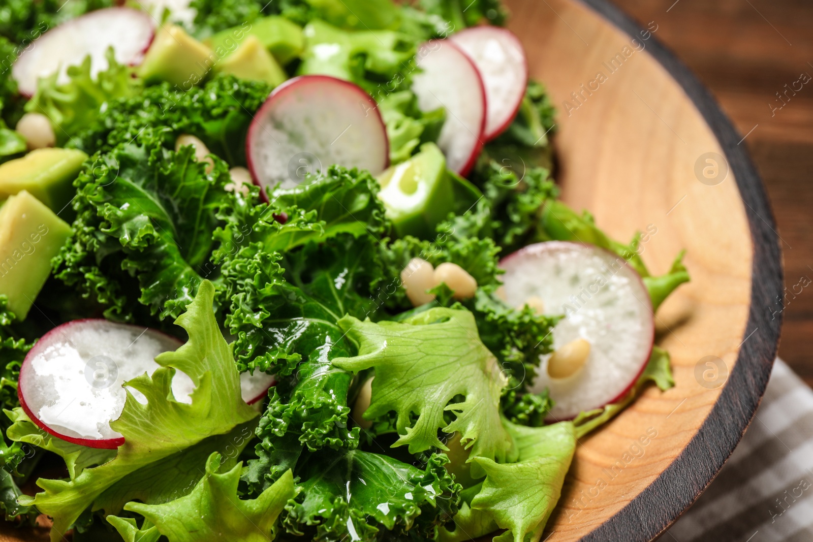 Photo of Delicious salad with kale leaves on table, closeup