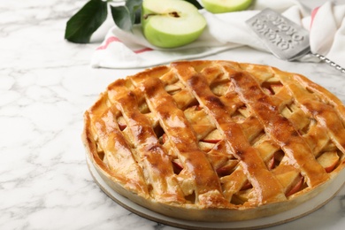 Photo of Fresh traditional apple pie on white marble table