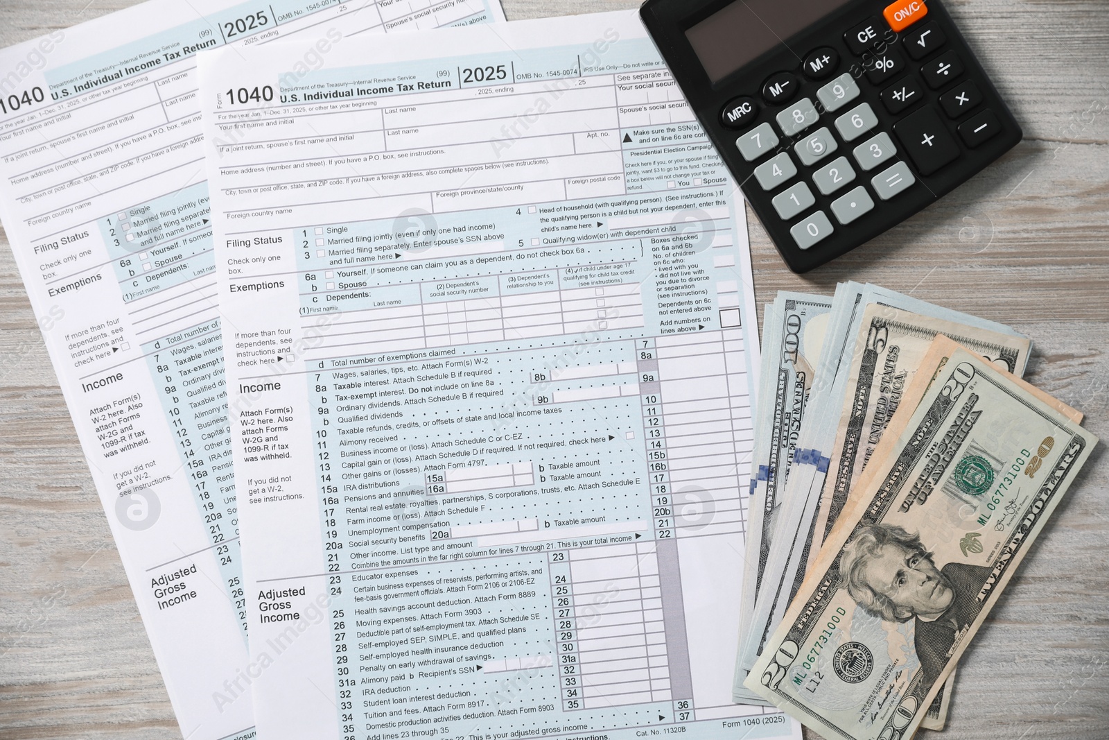 Photo of Payroll. Tax return forms, calculator and dollar banknotes on wooden table, flat lay