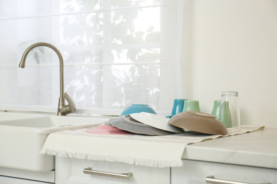 Clean dishes drying on counter in kitchen