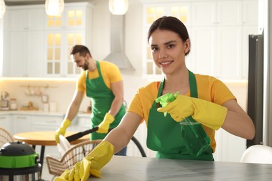 Photo of Professional janitors working in apartment. Cleaning service