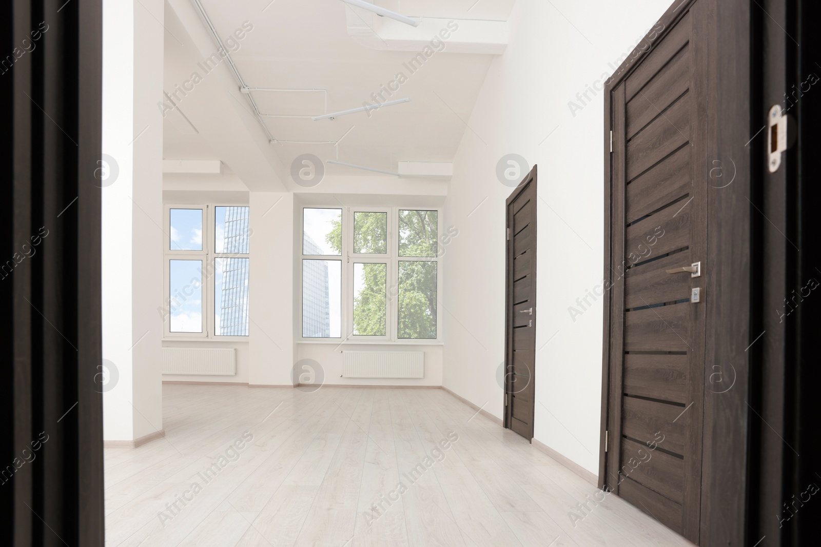 Photo of Modern office room with windows and doors. Interior design