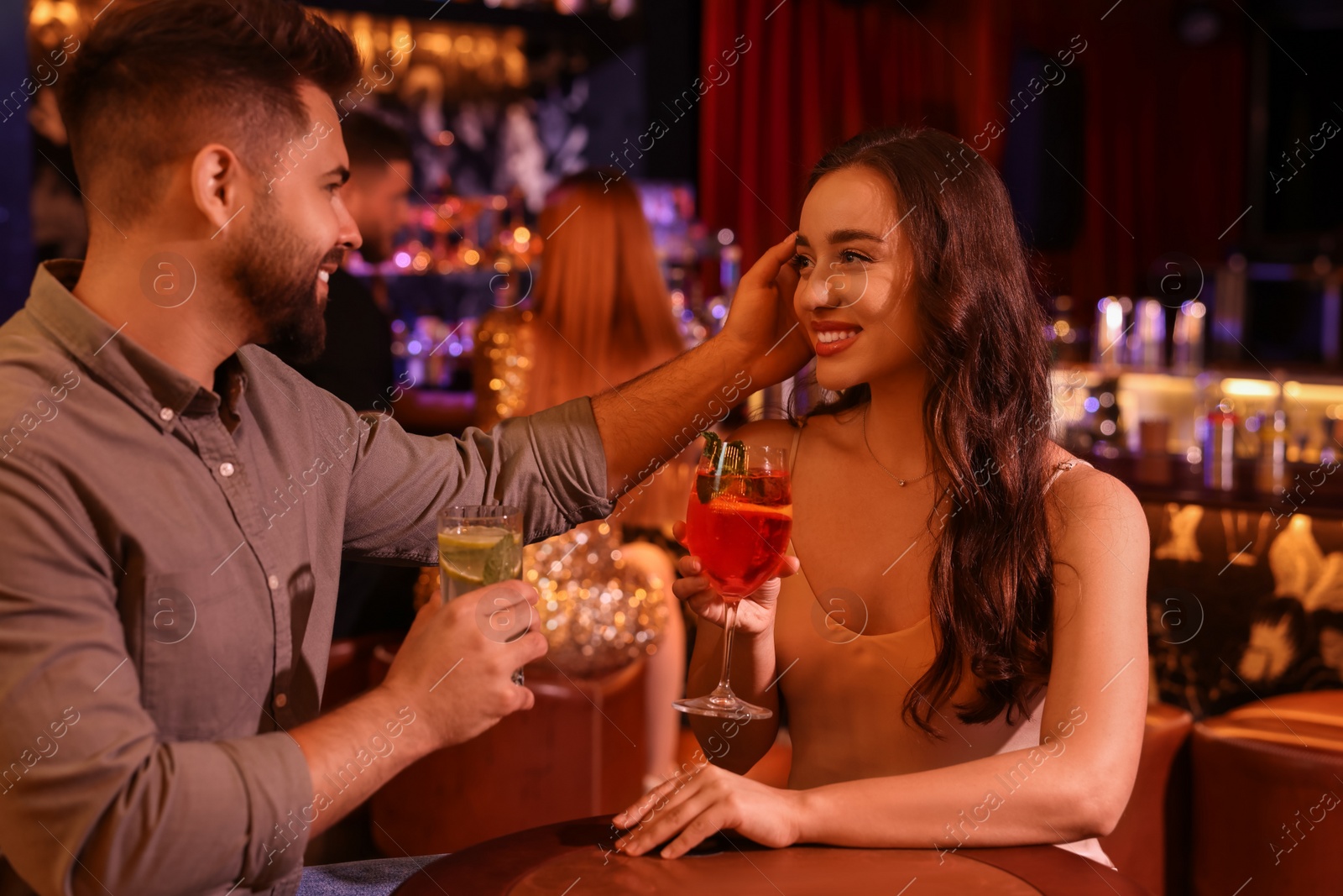 Photo of Lovely couple with fresh cocktails in bar