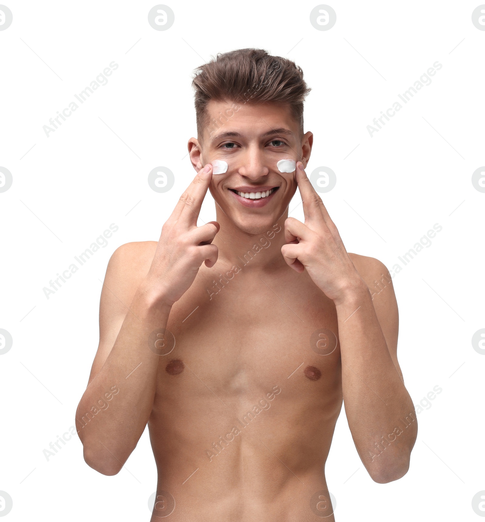 Photo of Handsome man applying moisturizing cream onto his face on white background