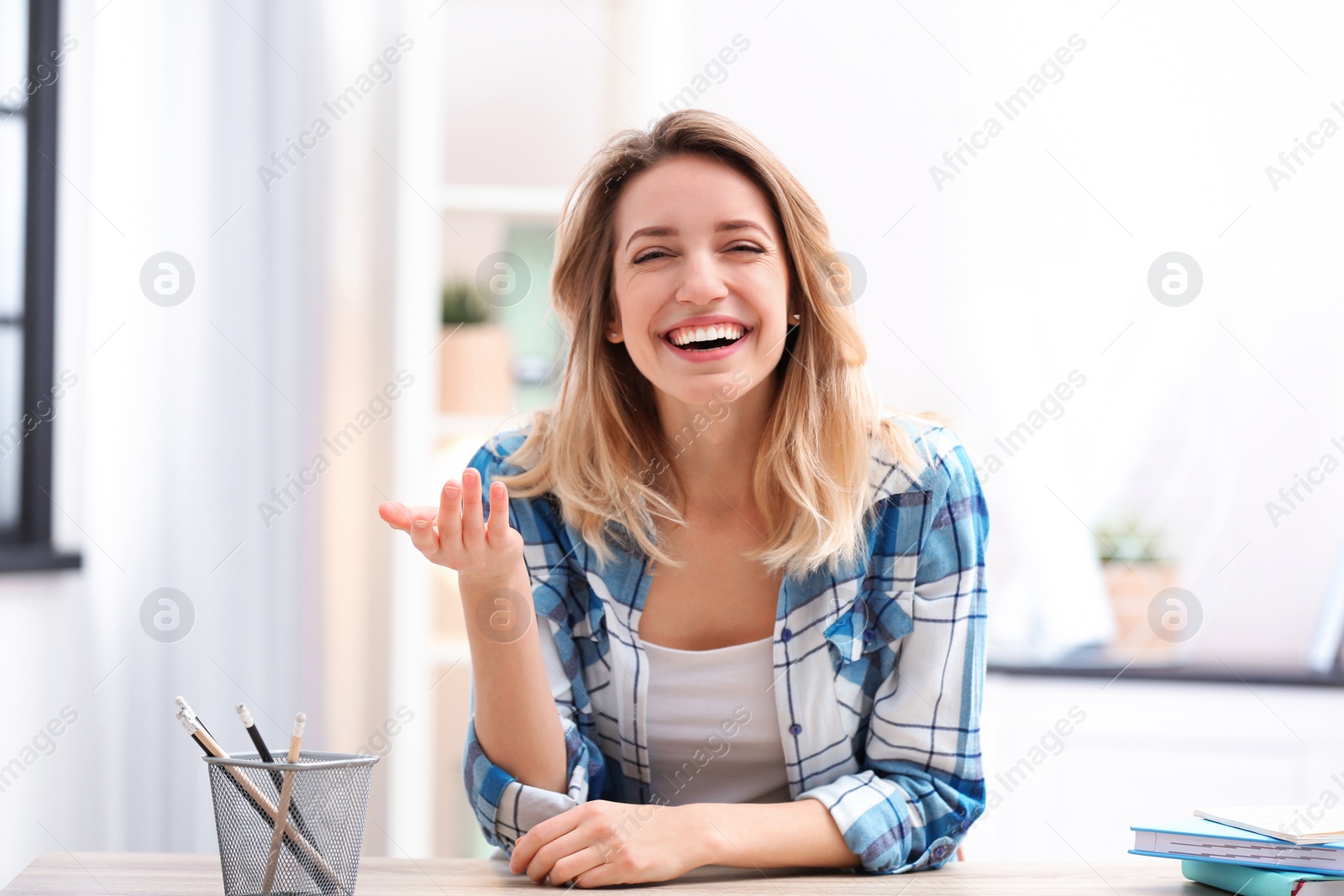 Photo of Beautiful woman using video chat for conversation indoors