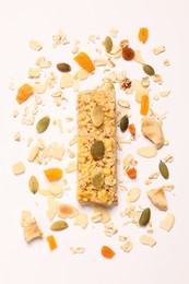 Photo of Tasty granola bar and ingredients isolated on white, top view