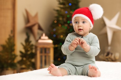 Cute little baby in room decorated for Christmas. Winter holiday