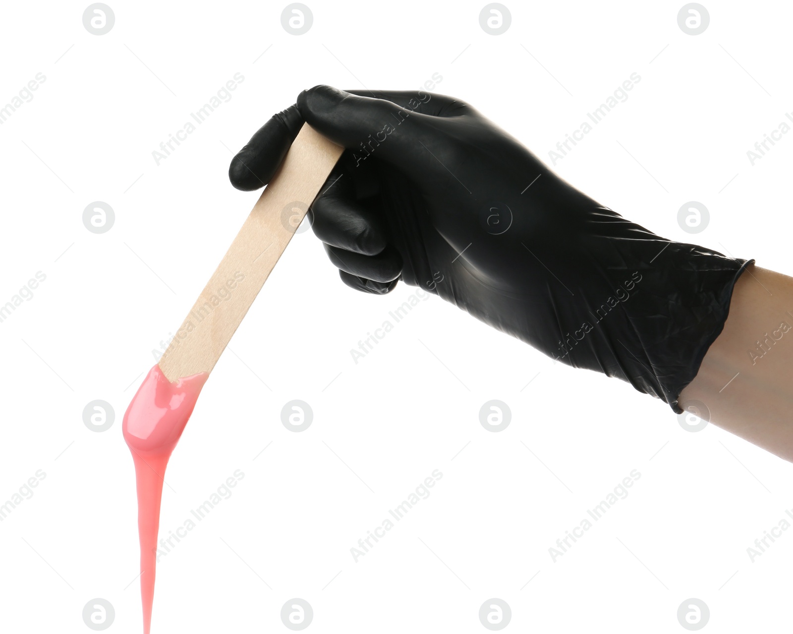 Photo of Woman in gloves holding spatula with hot depilatory wax on white background, closeup